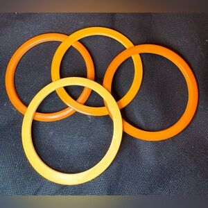 Bundle of 4 vintage Bakelite spacer bangles/bracelets orange and yellow